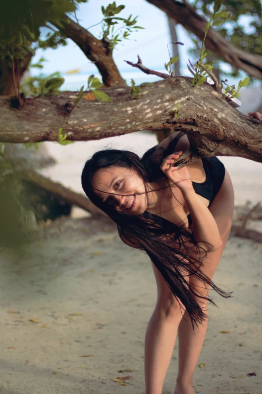 a  posing next to a tree nch