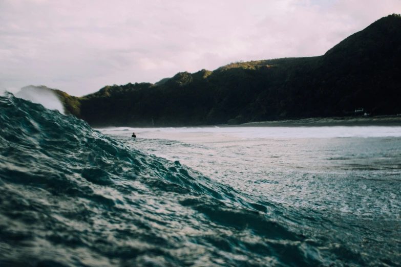 a surfer in the ocean riding a large wave