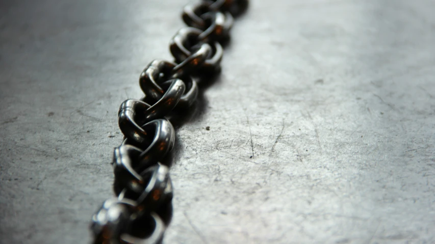 an iron chain with lots of knots hanging off it