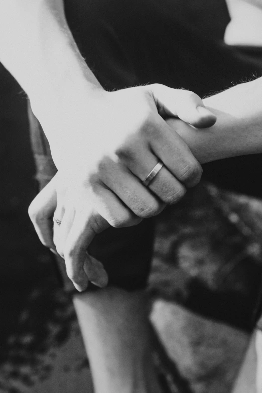 two people holding hands while sitting down