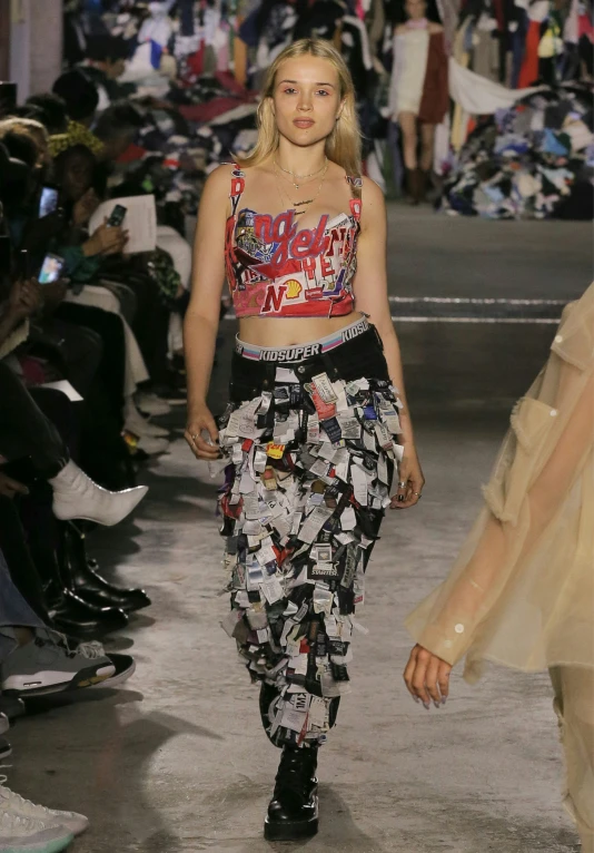model with crop top and flowery pants on runway
