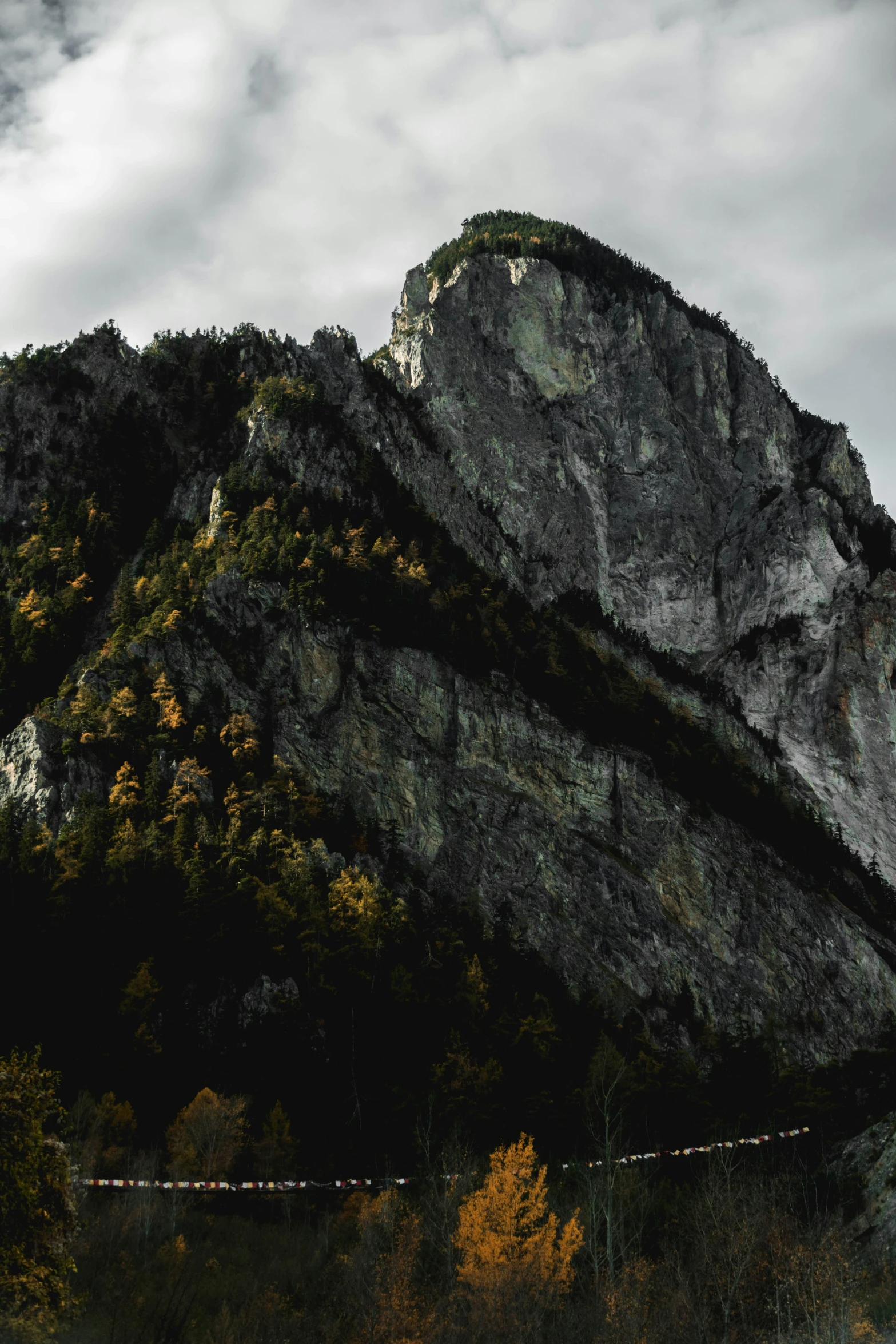 the top of a rock mountain with a wire over it