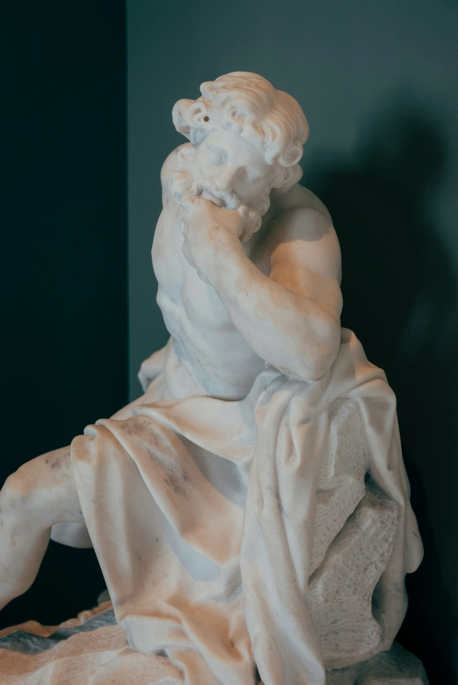 a statue sitting on top of a white pedestal