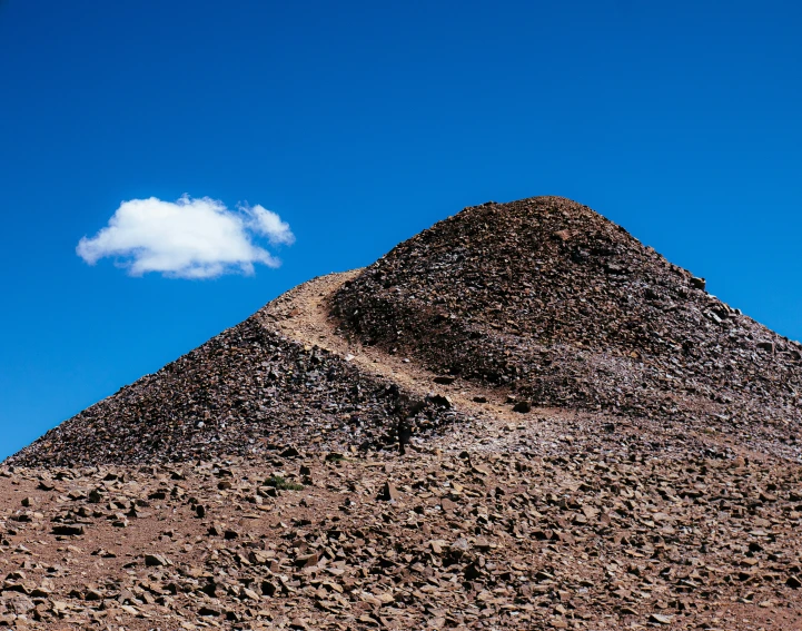 a very tall mountain on the side of a desert