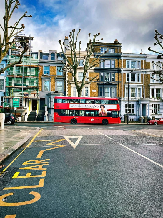 a bus driving on the road next to tall buildings