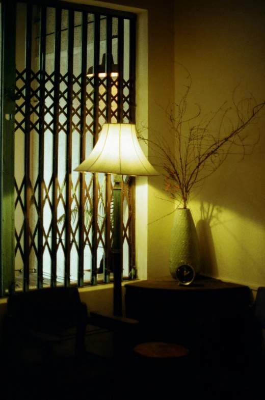 a lamp sitting on a table next to a window