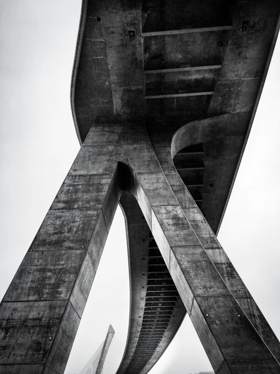 a man riding on the back of an airplane under a bridge