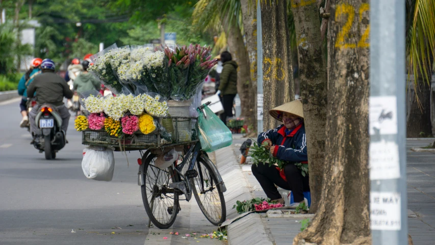 some people are walking and a person sitting on a bike