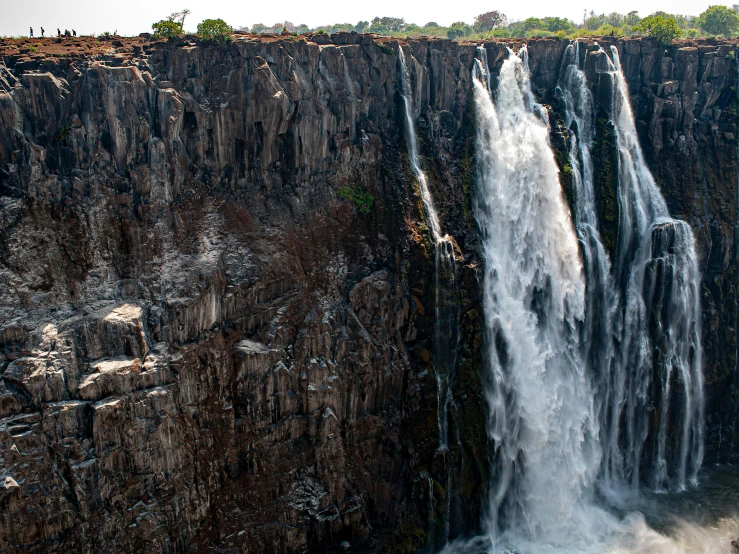 a very large waterfall in a big body of water