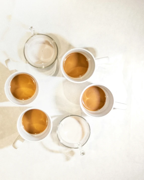 six coffee cups sitting in an arranged pattern