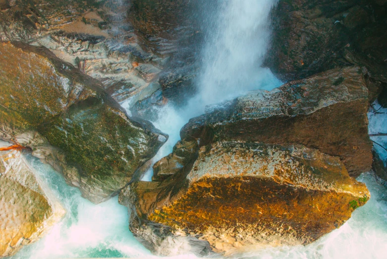 the waterfall is covered in moss and water