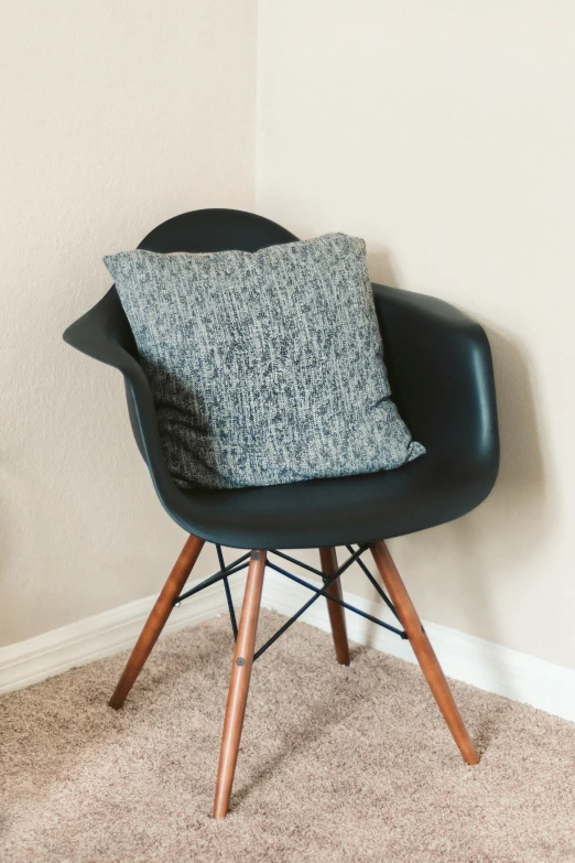 black and white pillow sitting on a chair