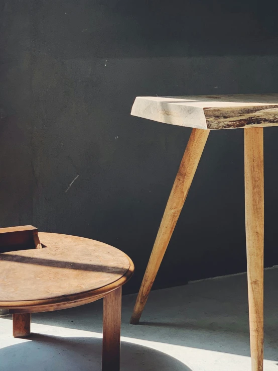 an old table sits next to an old wooden table