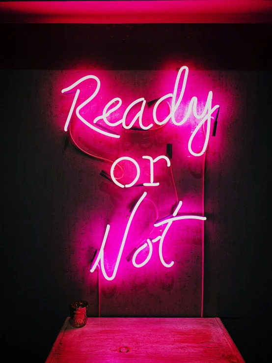 an neon sign that reads ready or not
