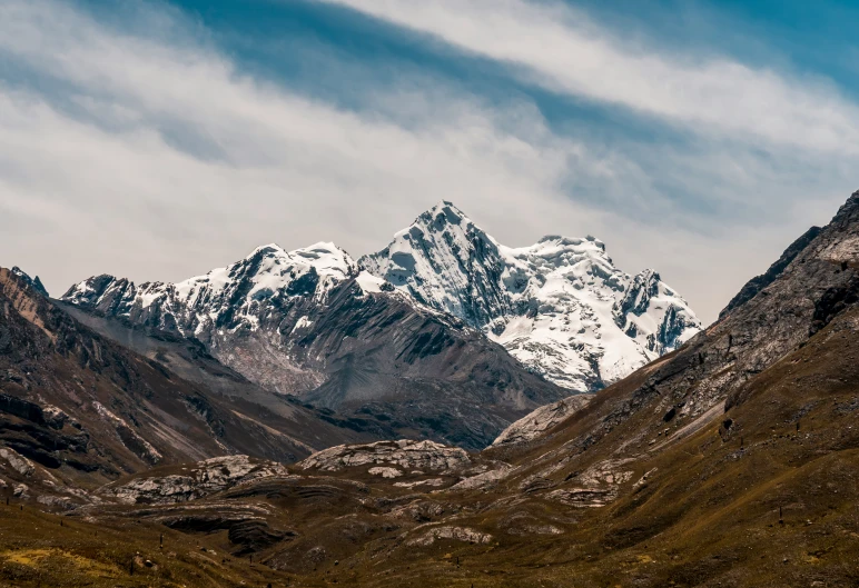 a large mountain covered with a white snow capped peak