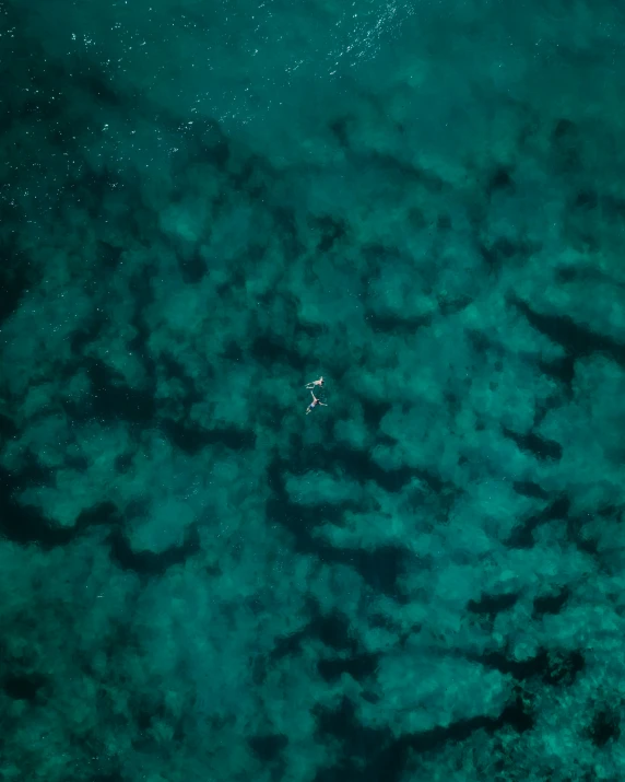 an aerial view of a body of water and some boats