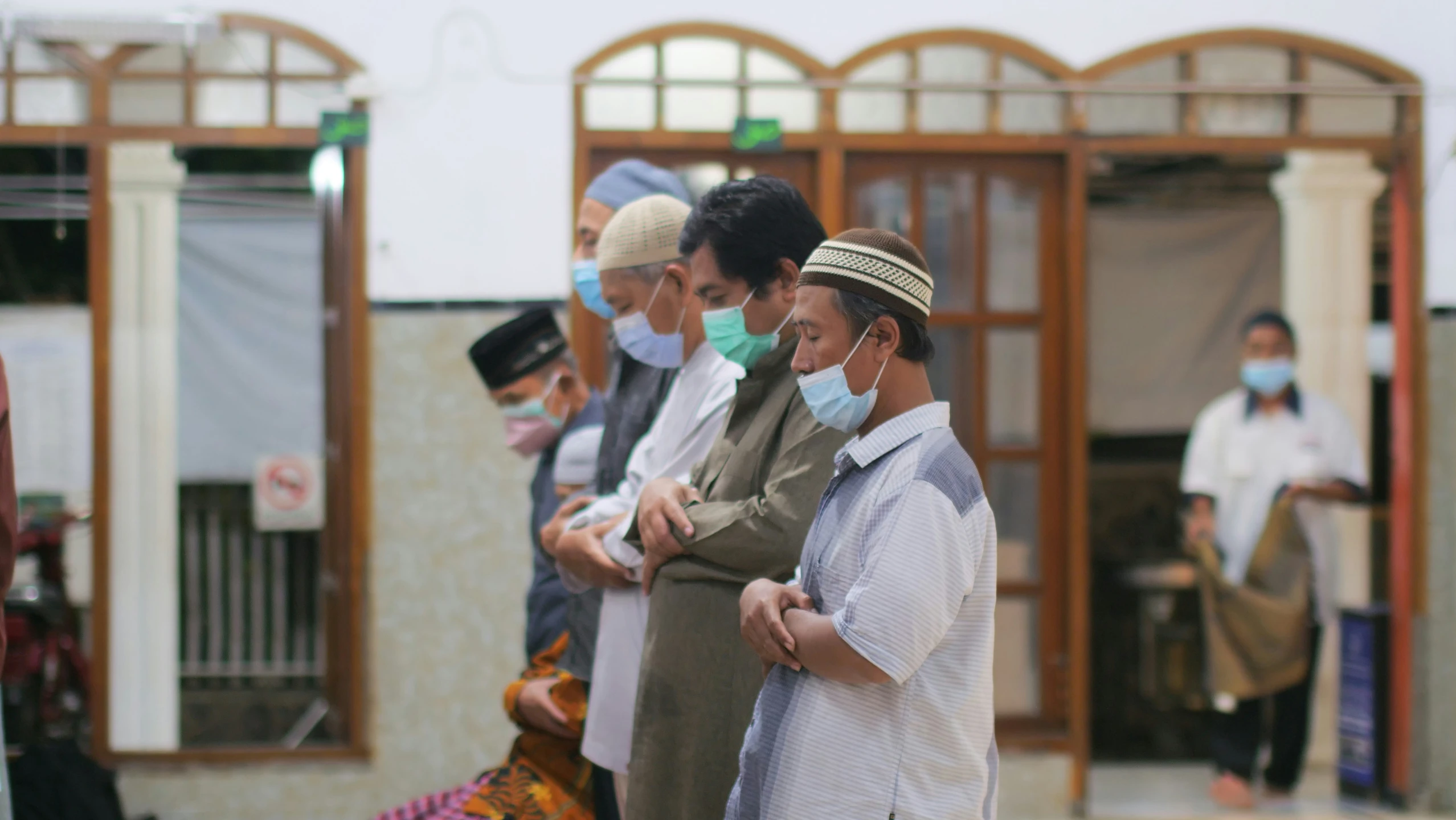 a group of people in surgical masks stand together