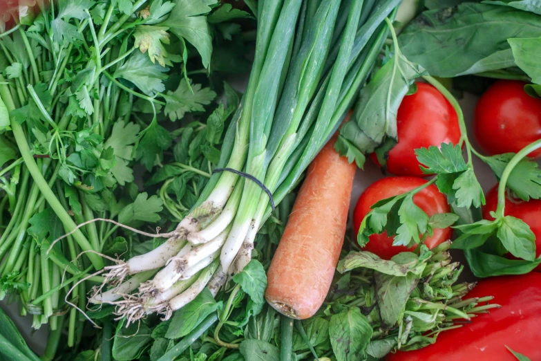 different kinds of vegetables sit on a table together