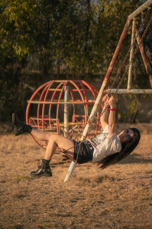 a woman on a swing being carried by a man