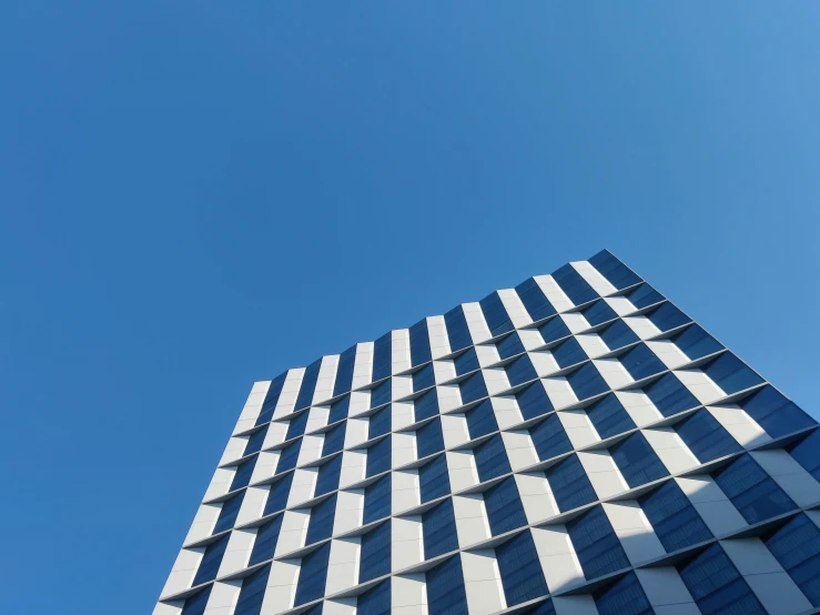 a modern skyscr with windows against the blue sky
