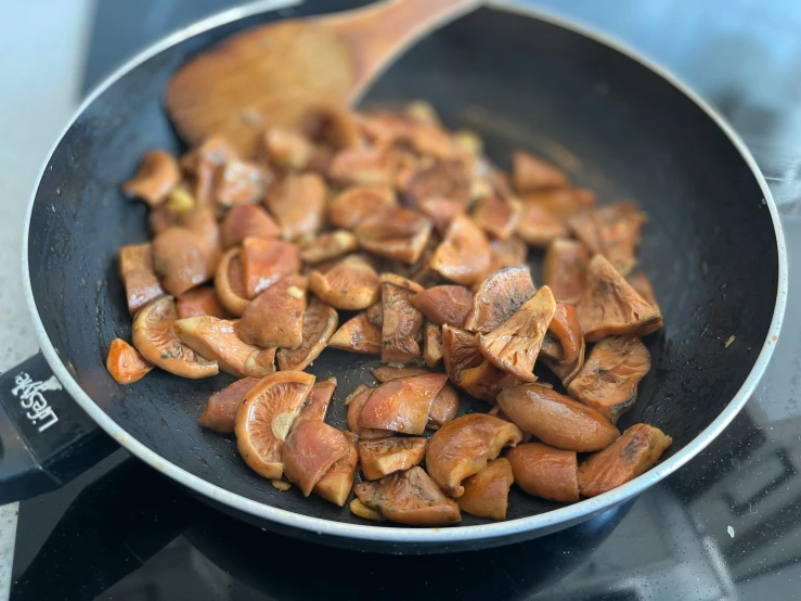 the food is being cooked in the pan on the stove