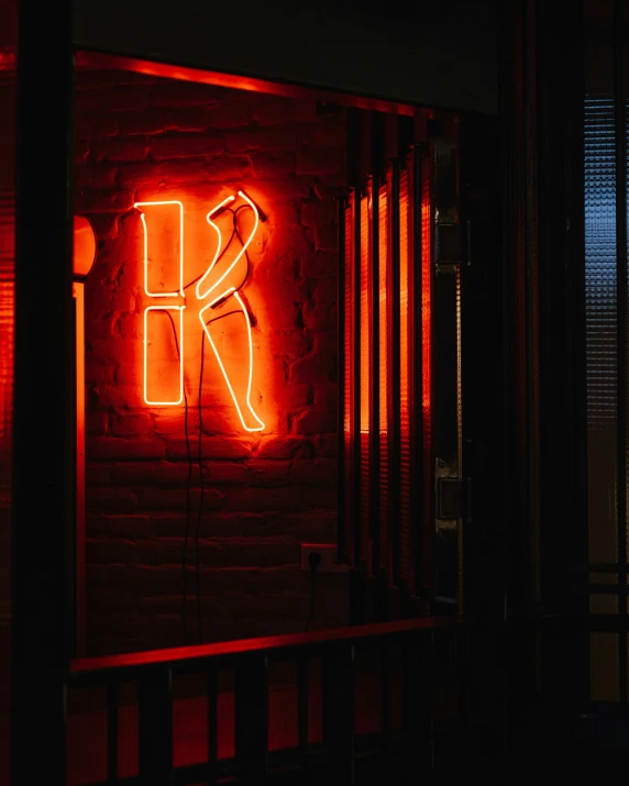 this neon sign is lit up at night