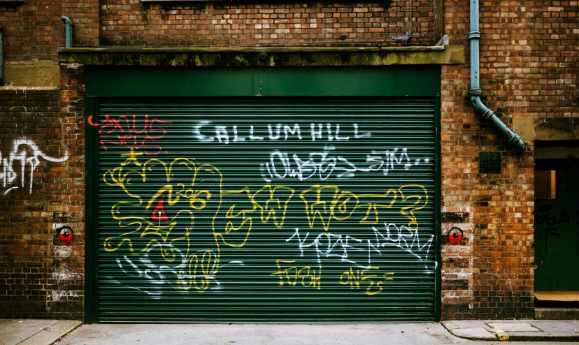 an old, run down garage with graffiti all over it