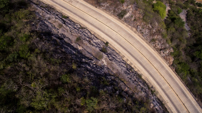 an aerial view of a road winding through the country side