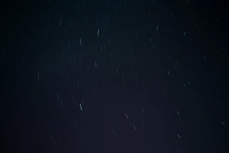 a star trails above a snow covered hill