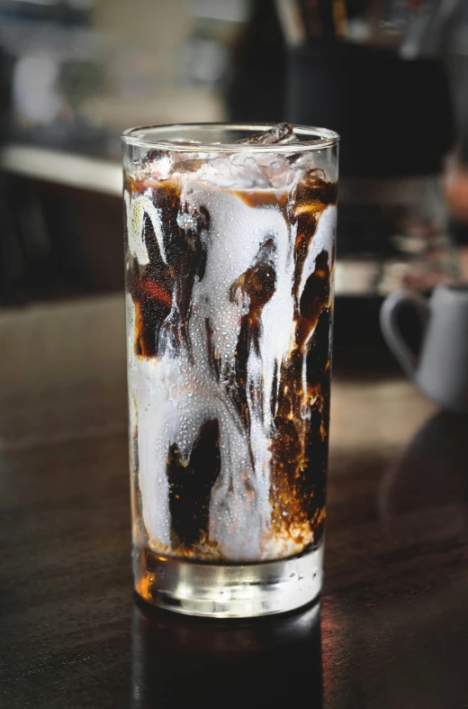 a glass with ice is on the table