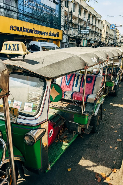 the colorful streetcars are parked along the sidewalk