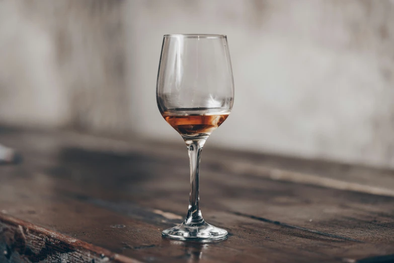 an empty wine glass sitting on a table