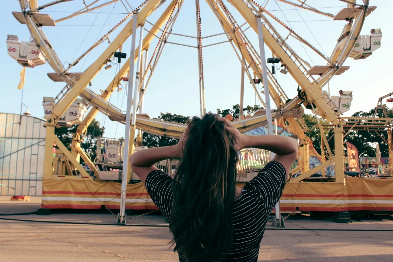 the woman is sitting alone at the carnival