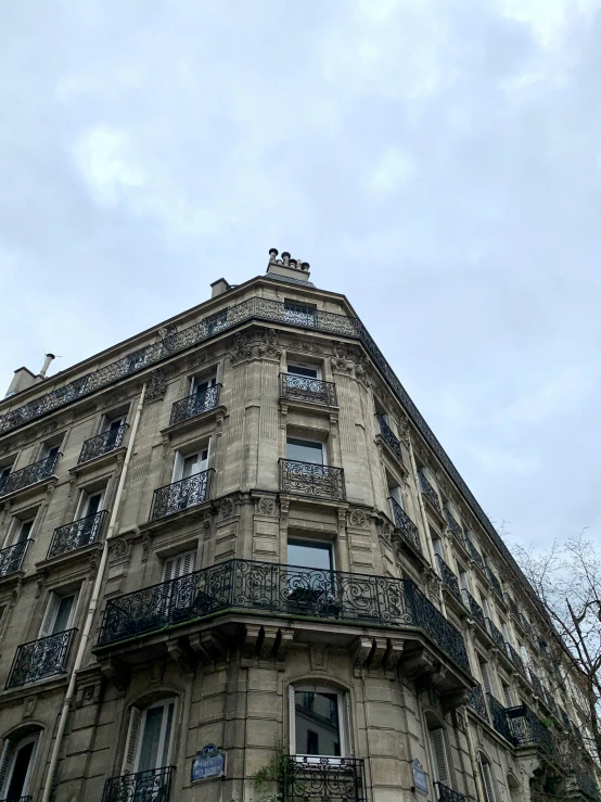 a tall building has an iron balcony and balconies