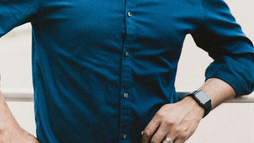 a man wearing a blue on up shirt