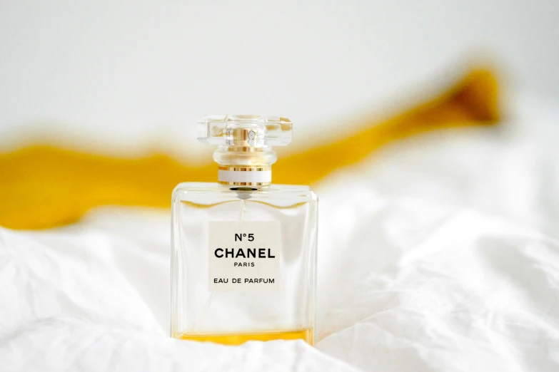 a bottle of perfume is sitting on the bed