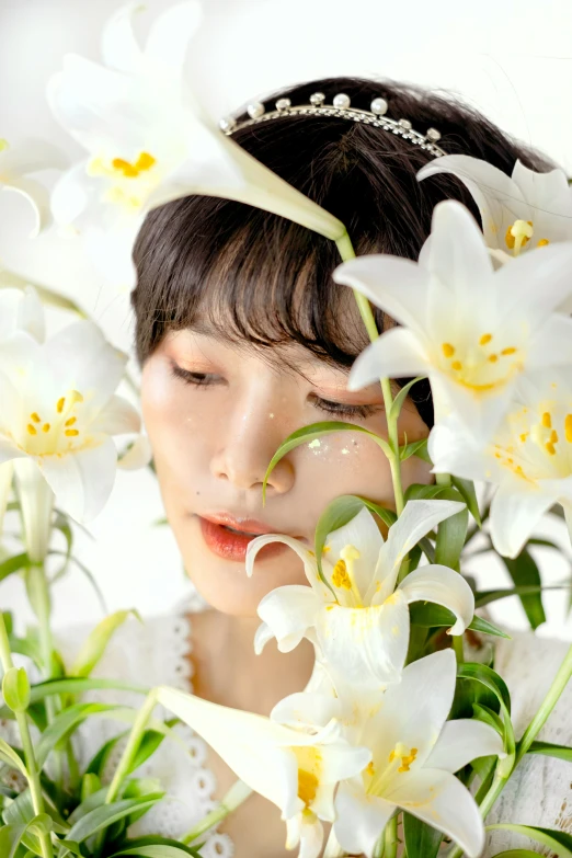 a woman with her face close to some flowers