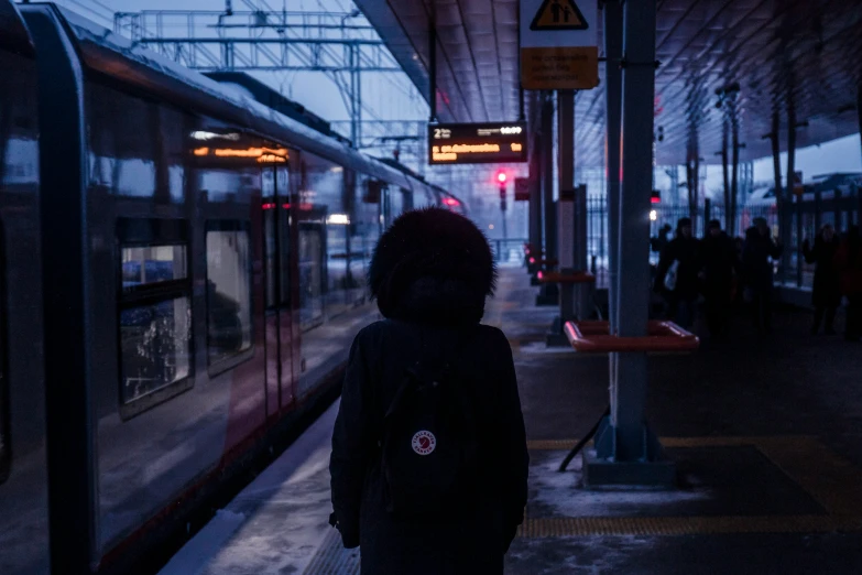 a dark image of a person waiting for a train