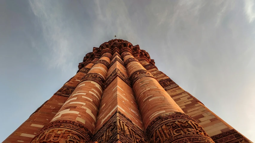 the view of a tall tower with intricate designs on the walls