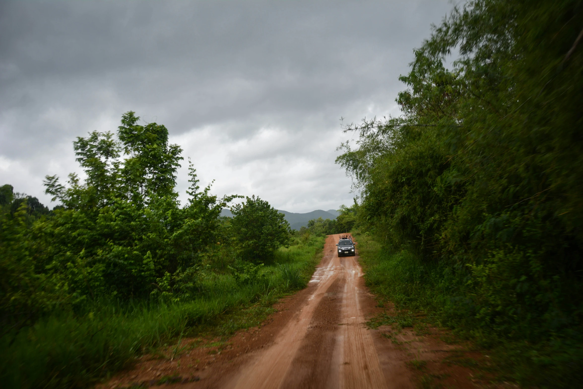 a vehicle that is on a dirt road