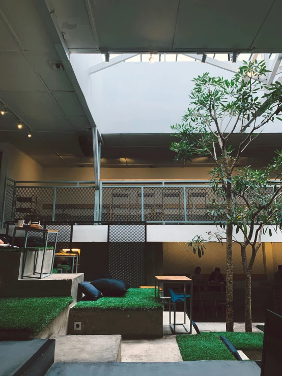 a room with grass and a tree in it