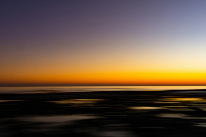 some surfers are surfing at sunset at the beach