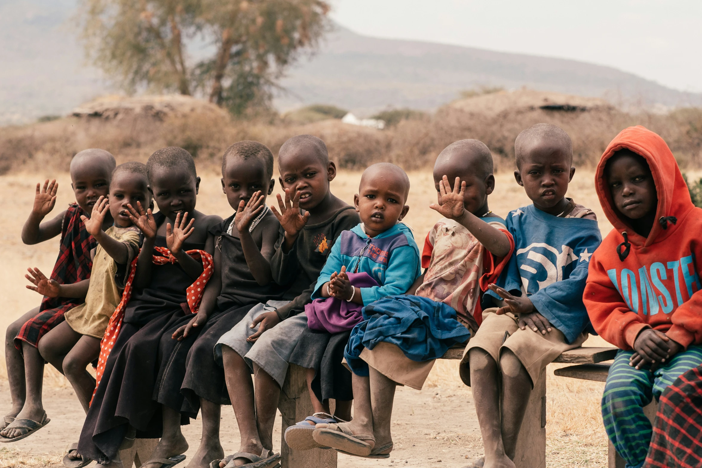 a group of small children sitting on top of a bench