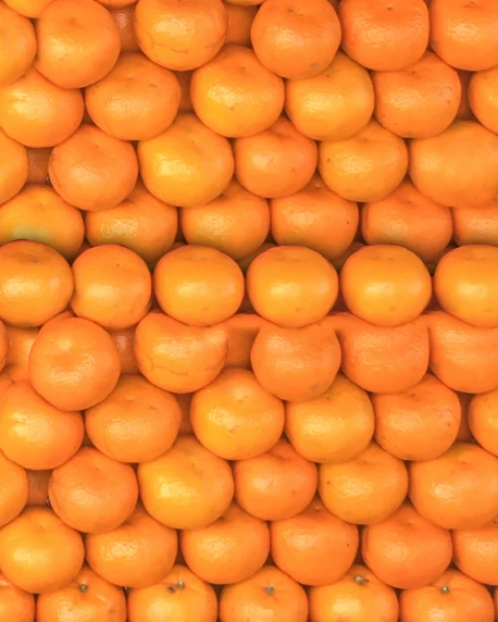 many oranges stacked on top of each other