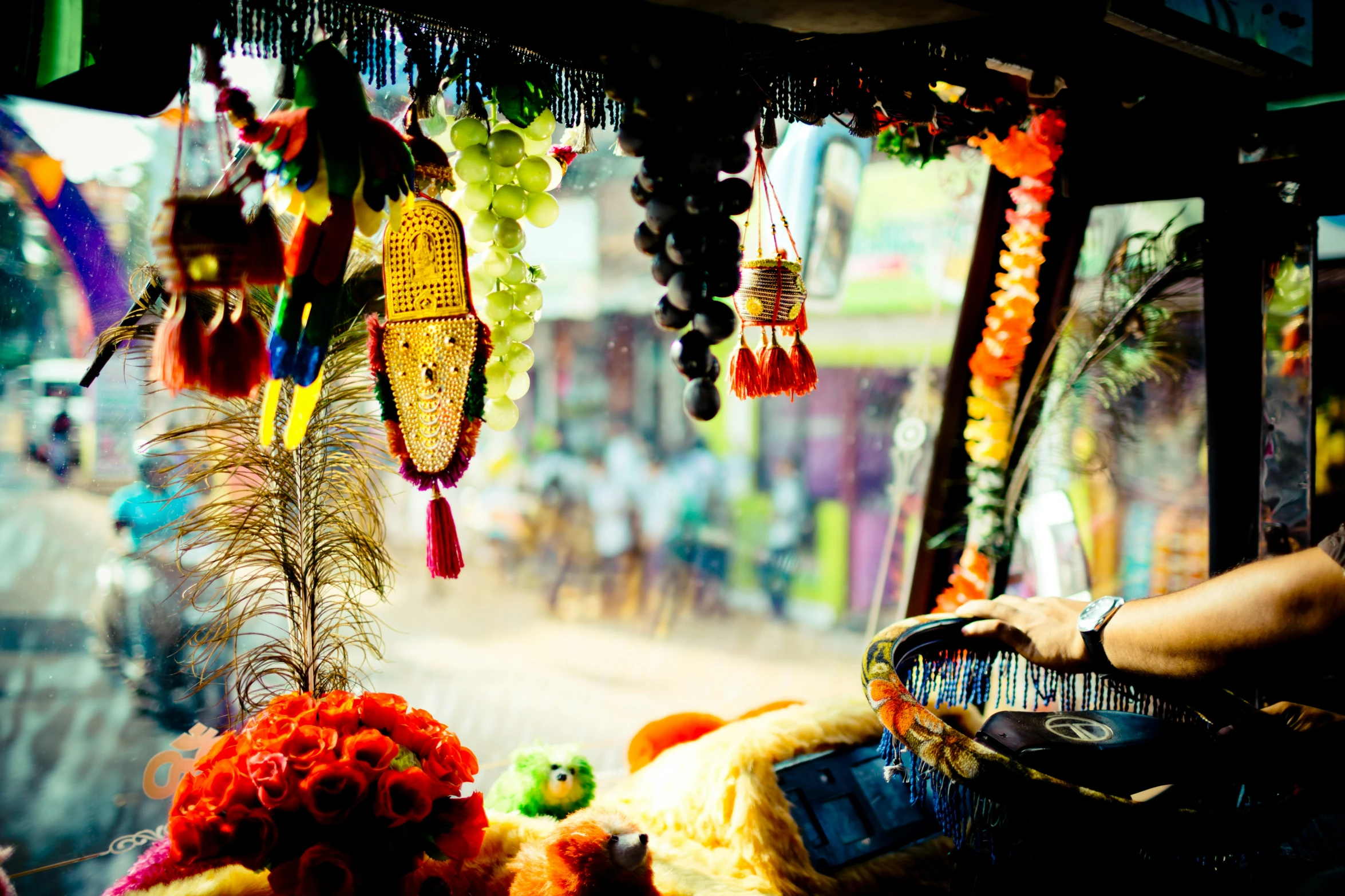 a person sitting in a chair surrounded by beads and flowers