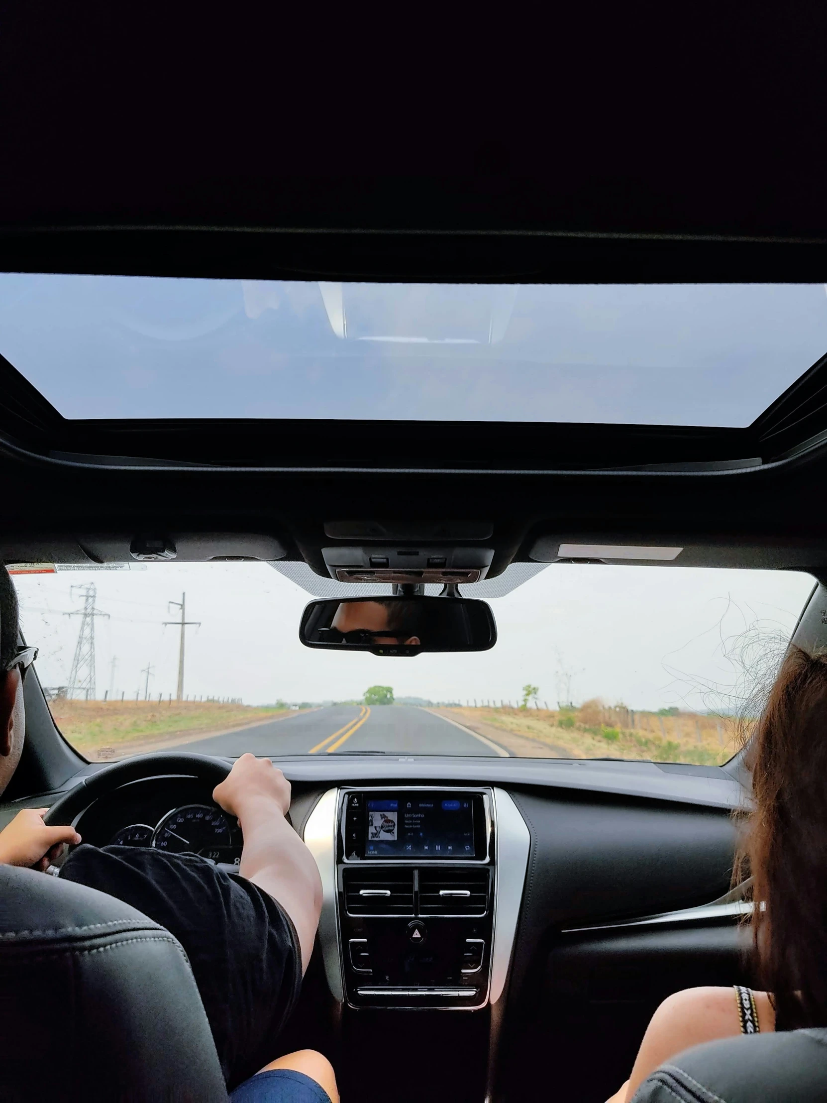 people in the passenger seat of a car looking at an information map