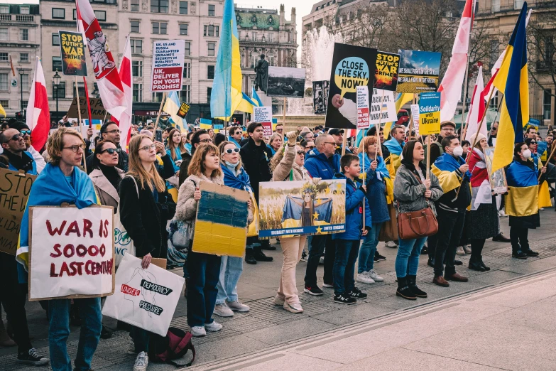 a large group of people marching together down a street