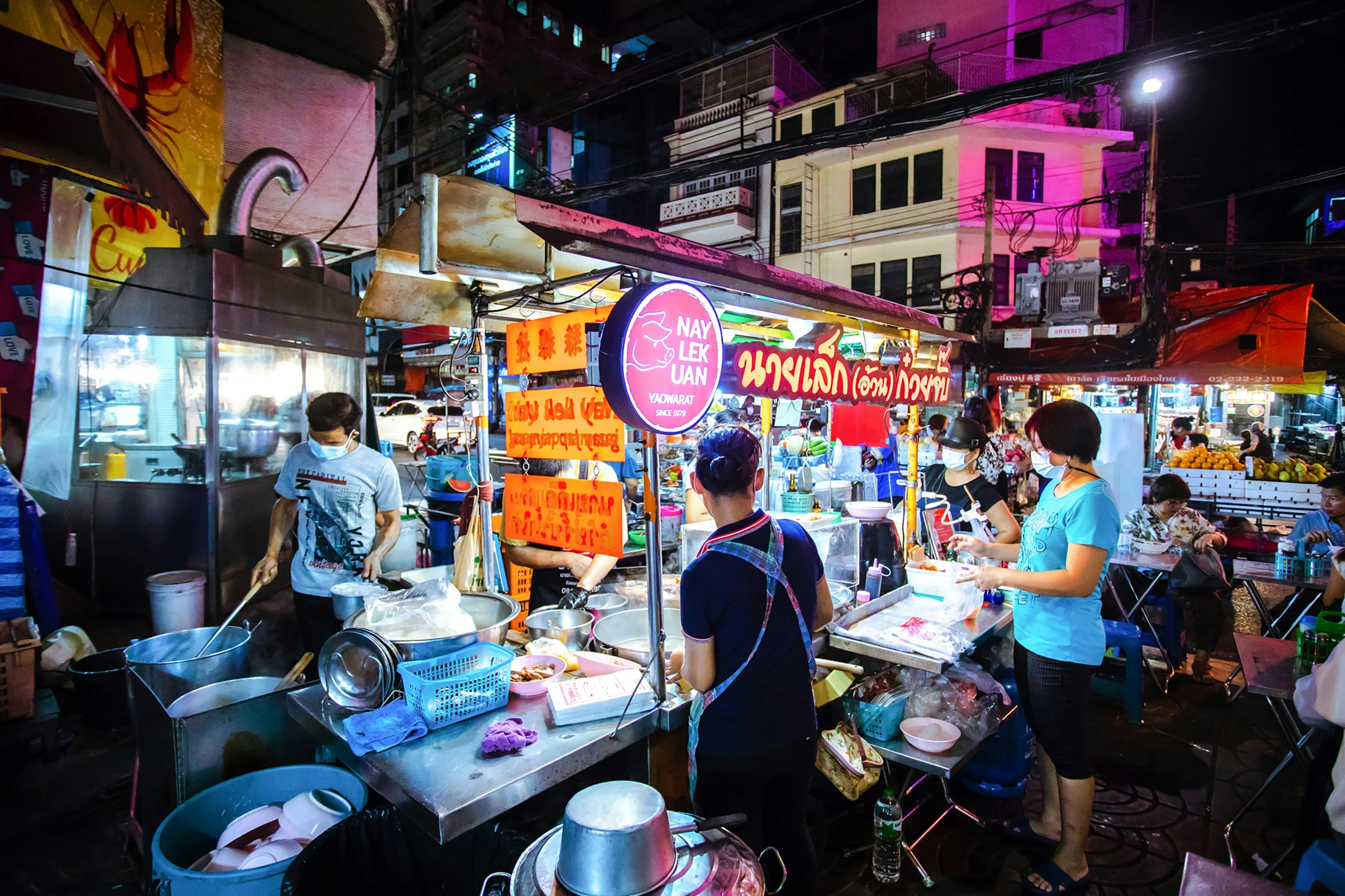 people at a market in the night time