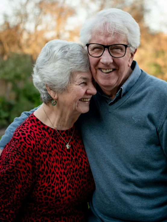 a close up of two people hugging each other