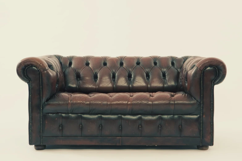 an old couch made from leather is shown